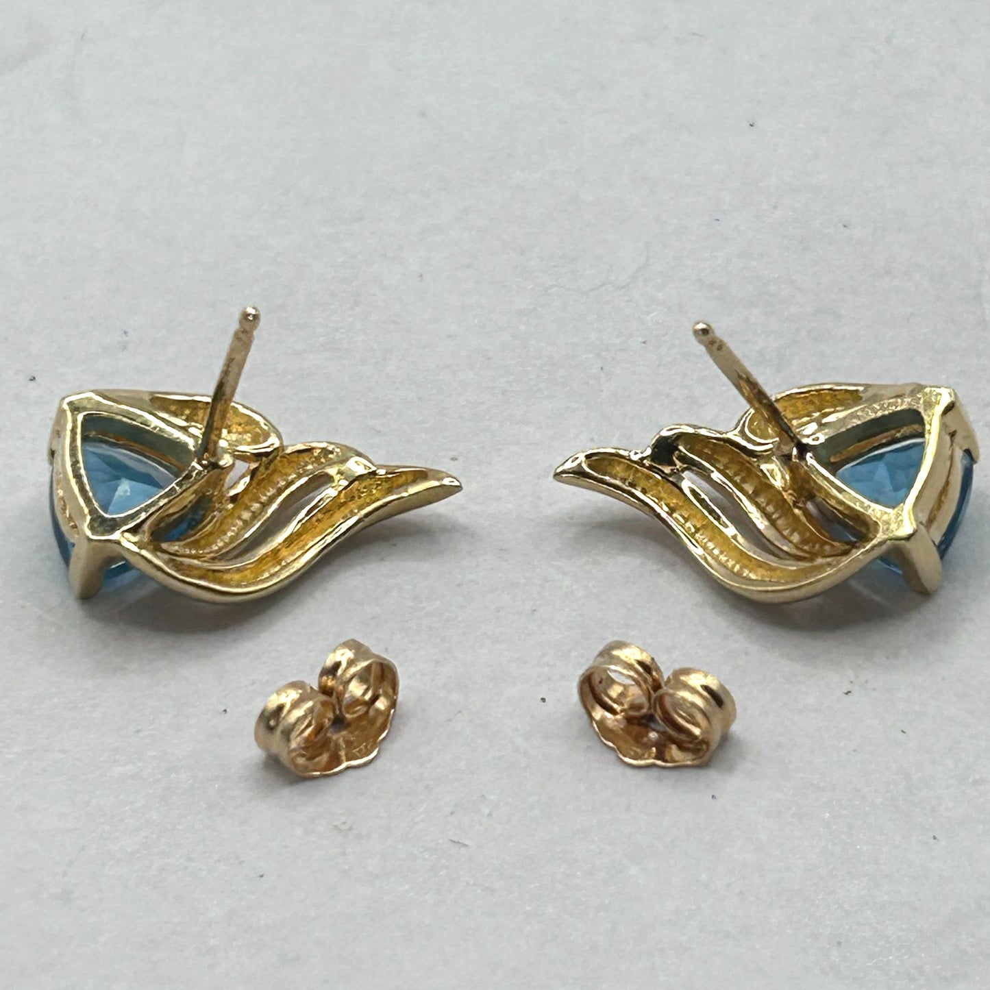 6.8mm Trillion Cut Blue Topaz 14k Yellow Gold Swirl Stud Earrings